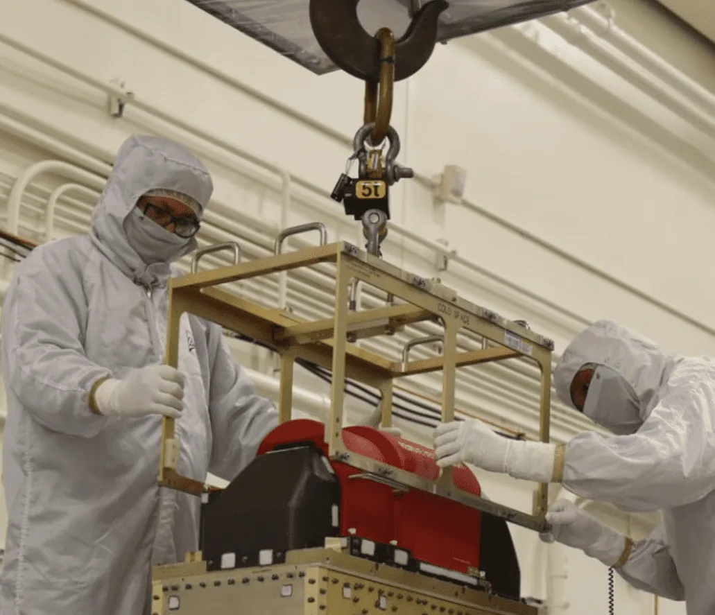 Ball Aerospace technicians use a 5-ton Eilon dynamometer to lower the ATMS instrument onto the JPSS-1 spacecraft