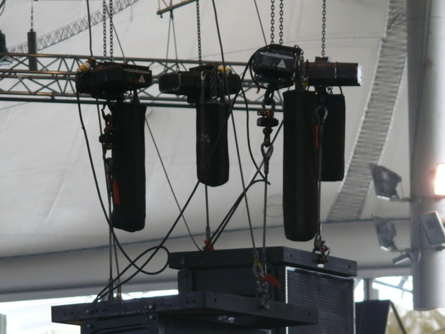 Hoists hanging from a ceiling with a blurred background