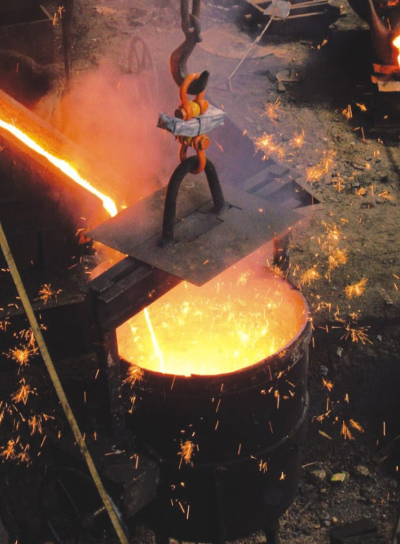 Person working with molten metal in a foundry