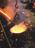Person working with molten metal in a foundry