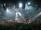 Large concert with a stage and audience in a large indoor arena.